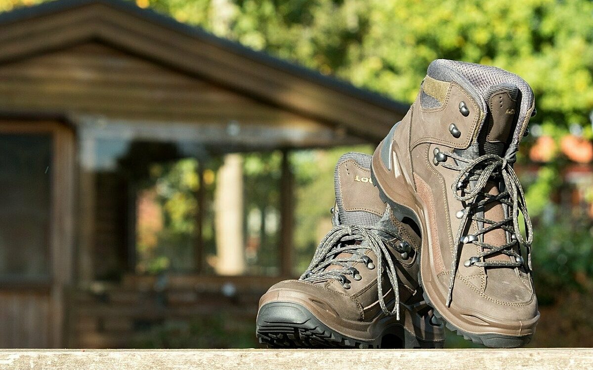 Wanderschuhe vor einer Hütte im Wald Wanderschuhe vor einer Hütte im Wald